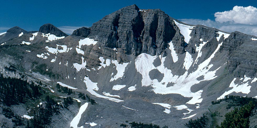 Limestone cliffs west of the taller peaks of the range were formed by ancient seas before the mountains' rise.