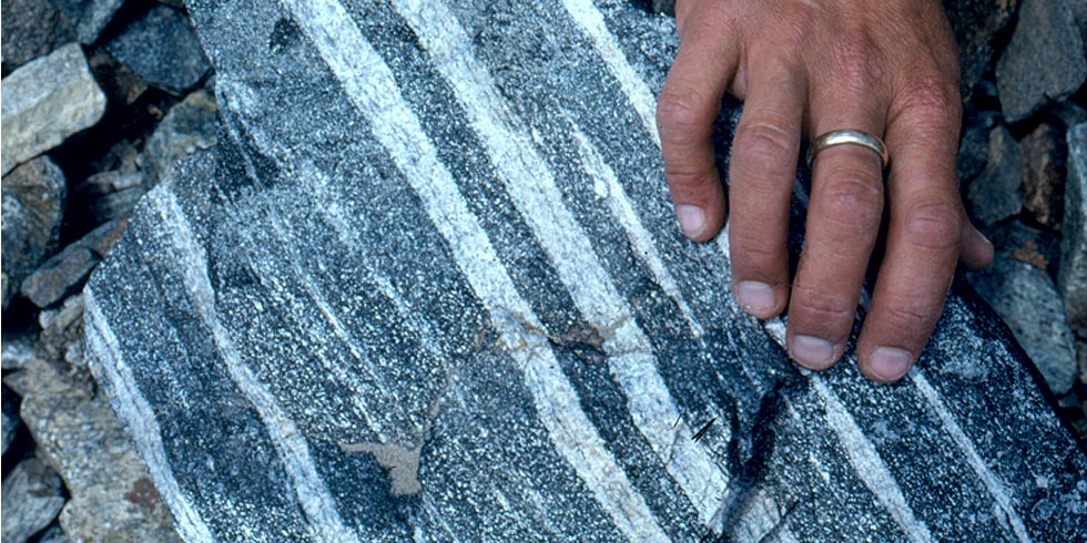 Layered gneiss, with dark gray and white, formed during metamorphism and are not the original rock layers.